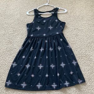 Girls black casual patterned dress, decorative lace straps and opening in back.